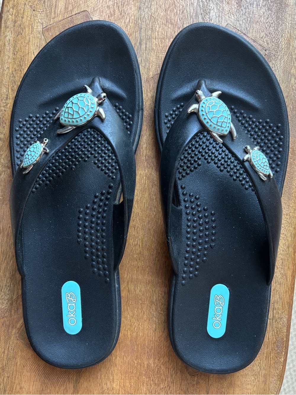 NWOT - OKA b. “Theresa” Black Flip Flops with Turquoise Turtle Charms - size M